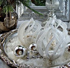 an ornate silver tray with ornaments on it