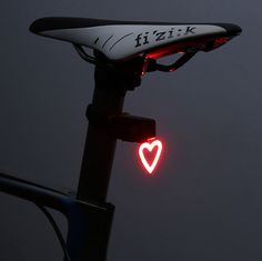 a bicycle light with a red heart on it