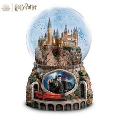 a snow globe with harry potter and hermione's hogwarts castle in it