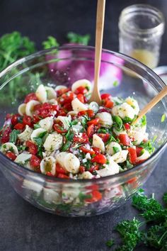 a bowl filled with pasta and vegetables on top of a table