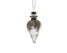 a glass ornament hanging from a chain on a white background with snow and ice