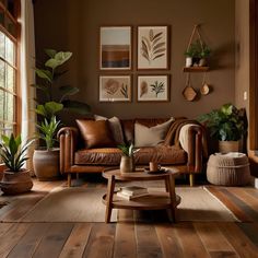 a living room filled with furniture and potted plants on top of a wooden floor