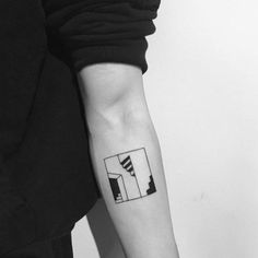 a black and white photo of a person with a tattoo on their arm