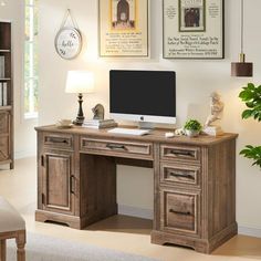 a desk with a computer on top of it in front of a book shelf and bookshelf