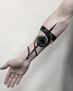 a black and white photo of a hand with a tattoo design on it's arm