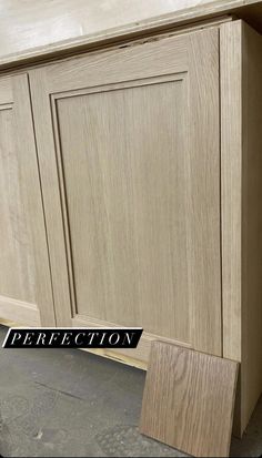 an unfinished cabinet door with the word perfection written on it