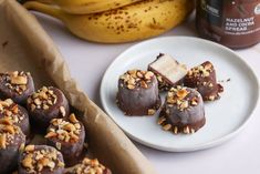 chocolate covered desserts and bananas on a table