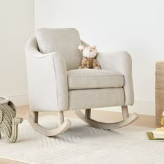 a rocking chair with a stuffed animal on it's back in a living room