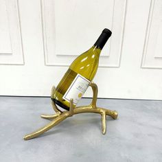 a wine bottle holder made out of gold antlers