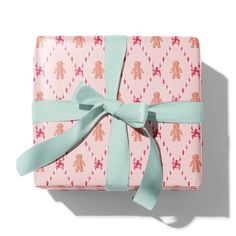 a wrapped gift box with a bow on it's side and the wrapping paper has an image of a teddy bear