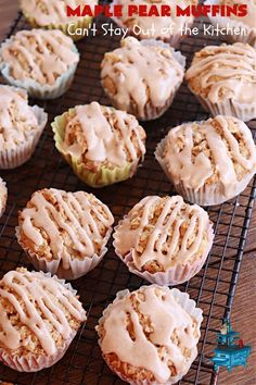 many muffins are cooling on a rack with icing and cinnamon sprinkles