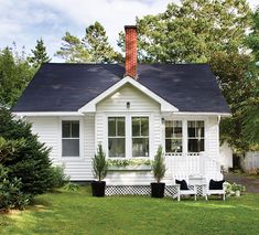 a white house with black roof and windows