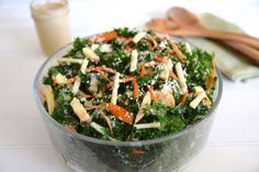 a salad with carrots, kale and parmesan cheese