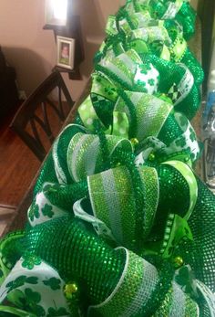 a green and white christmas tree sitting on top of a table