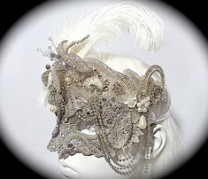 This opulent masquerade mask is platinum silver with lace overlays and gorgeous vintage rhinestone appliques that surround the top and cheeks. It is a very difficult to photograph rhinestones and silver but trust that this is a very silvery and sparkly mask! A vintage jewelry piece and a silver beaded flower are center on the forehead. The molded mask is loaded with rhinestones, gems, and vintage bead accents. Pearl drops & loops of rhinestone chain add elegant touches to this Art Deco style mas Luxury Silver Masks And Prosthetics For Masquerade, Luxury Silver Masks For Masquerade, 18th Bday Ideas, Masquerade Mask Costume, Victorian Accessories, Silver Mask, Event Decor Ideas, Custom Headbands, 18th Bday