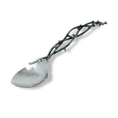 a metal spoon sitting on top of a white surface