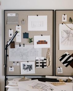 a table topped with papers and pictures next to a microphone