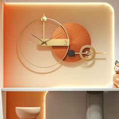 an orange clock sitting on top of a white shelf next to a teddy bear and vase