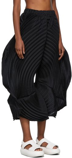 Wide-leg garment-pleated trousers in black. Mid-rise. Elasticized waistband. Cut-out at modified inseam. Supplier color: Black Issey Miyake Pleated Pants Men, Issey Miyake Pleats Please Street Style, Issey Miyake Pleats Please Outfit, Issey Miyake Pleats Please Pants, Issey Miyake Dress Pleats, Black Curls, Solid Skirt, Stretch Skirt, Pleated Trousers