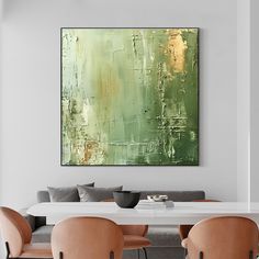 an abstract painting hangs above a dining room table