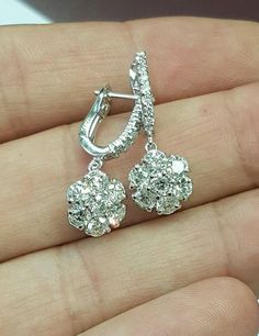 Amazingly beautiful all natural not enhanced diamond 14k solid white gold dangling flower earrings. Weight: 4.3 grams Flower size appx: 10 mm diameter Total length appx: 25 mm Total number of diamonds: 28 round shape Total diamond weight: 2.28 Ct Clarity: SI2 Color: H-I Type of fastening: Lever back COMES IN A NICE GIFT BOX! Please add me to your Favorites list White Gold Diamond Dangle Cluster Earrings, White Gold Diamond Cluster Dangle Earrings, Gia Certified White Gold Dangle Diamond Earrings, Gia Certified Dangle White Gold Diamond Earrings, Gia Certified Dangle Diamond Earrings In White Gold, Diamond Drop Flower Earrings In Fine Jewelry Style, Diamond Flower Drop Earrings For Anniversary, Vintage Style Wedding Rings, Flower Cluster