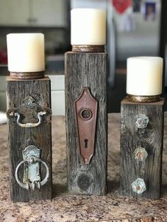 three wooden candlesticks sitting on top of a counter