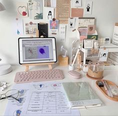 a computer monitor sitting on top of a desk next to a keyboard and mouse pad