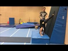 a man standing on top of a blue trampoline