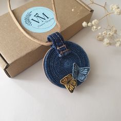 a blue bag with a butterfly on it next to a box