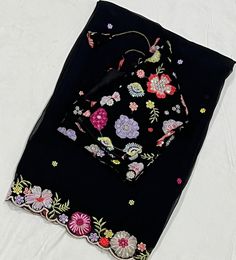 *Category: Women's Ethnic Wear *Fabric: Georgette *Color: Black with Multicolor Floral Embroidery *Blouse Size: 34-42 inches (adjustable) *Border: Floral Embroidery *Occasion: Suitable for festive occasions, weddings, and parties  This elegant  Georgette saree features a beautifully detailed floral embroidery border, making it perfect for any special occasion. The matching blouse piece can be tailored to fit sizes 34-44 inches. Enhance your wardrobe with this timeless piece. Disclaimer: There mi Wedding Georgette Blouse With Embroidered Border, Floral Embroidered Georgette Blouse With Traditional Drape, Transitional Blouse With Embroidered Border And Traditional Drape, Bollywood Style Georgette Blouse With Embroidered Border, Bollywood-style Georgette Blouse With Embroidered Border, Designer Georgette Blouse With Embroidered Border, Eid Saree Blouse With Embroidered Border, Festive Georgette Blouse With Embroidered Border, Bohemian Georgette Blouse With Zari Work