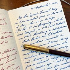 an open notebook with writing on it and a fountain pen resting on the page next to it