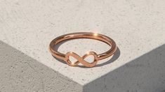 A beautiful Solid 9ct Rose Gold Infinity Ring. Special and powerful, the infinity symbol represents unending love, hope and eternity, making this necklace a fantastic anniversary, valentines, or mothers day gift idea, or even a little treat for yourself or a friend.  Synonymous with loyalty, many people believe the symbol represents limitless opportunity. Implying that something will last forever. This dainty ring shank is 1.5mm wide and the infinity symbol has a width of 10mm and a height of 4. Symbolic Rose Gold Promise Jewelry, Rose Gold Infinity Promise Jewelry, Rose Gold Infinity Jewelry For Promise, Hypoallergenic Rose Gold Infinity Jewelry, Minimalist Infinity Jewelry For Promise, Symbolic Infinity Jewelry For Anniversary, Dainty Rose Gold Infinity Jewelry, Infinity Rose Gold Promise Ring, Rose Gold Infinity Ring For Promise