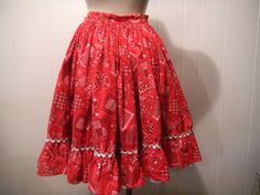 "Vintage 1950s Rockabilly square dance bandana skirt. Made of red cotton. Has a side zipper and white cotton trimmed lower hem. No label. Size small. Actual measurements are: 27\" at the waist 25\" overall length. In good condition. Two small wear holes on the waistband(photos)." Vintage Red Ruffled Skirt, Vintage Red Skirt With Ruffles, Vintage Red Fitted Petticoat, Retro Red Cotton Skirt, Vintage Red Cotton Skirt, Retro Cotton Skirt With Ruffles, Bandana Skirt, Rockabilly Skirt, 1950s Rockabilly