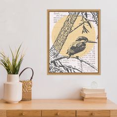 a bird sitting on top of a tree branch in front of a yellow and black painting