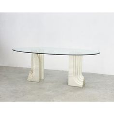 a glass table sitting on top of a cement floor