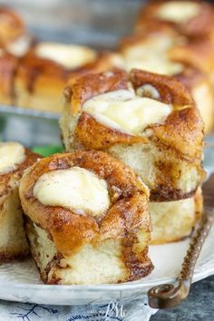 some cinnamon rolls are on a plate and ready to be eaten