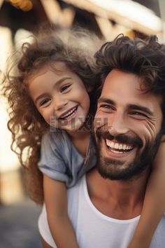 A man holds a little girl on his shoulders, both of them smiling as they share a delightful moment together. Their happiness is evident as they look at the camera. #freepixel #photo #fathersdaycard #happyfathersday #fathersday #fatherlove #father Super Dad