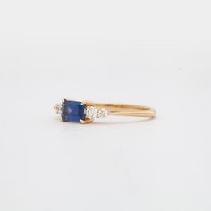 The high contrast combination of vivid blue sapphires and twinkling white diamonds has stood the test of time and Anna Sheffield makes it her own with this compact ring that's easy to wear, yet loaded with personality. The east-west setting is a perfect way to turn a sizable sapphire into an everyday statement. Understated brides and gemstone lovers will both find something to love about this ring. Designed in New York. 14 karat gold set with an approximately 0.75 carat (6 mm x 4 mm) emerald-cut Timeless Blue Sapphire Ring, Timeless Blue Diamond Ring, Timeless Blue Sapphire Cluster Ring, Timeless Sapphire Diamond Ring With Vvs Clarity, Timeless Blue Diamond Ring With Accents, Rings With Diamonds, Anna Sheffield, Find A Boyfriend, Rings Blue