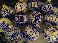 twelve blue and white christmas ornaments with the letter j on one ornament, each decorated in different designs