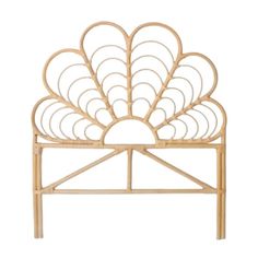 the headboard is made out of bamboo and has an intricate fan design on it