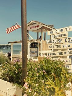 there is a sign that says welcome to paradise cove and the beach in front of it