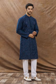 Navy kurta with diamond embroidery and mandarin collar. Paired with churidar.
Component: 2
Pattern: Embroidered
Type Of Work: Diamond
Neckline: Mandarin
Sleeve Type: Full Sleeves
Fabric: Cotton Blend
Color: Blue
Other Details: 
Embroidered motifs
Occasion: Puja - Aza Fashions Kurta Set For Men, Embroidered Motifs, Types Of Work, Luxury Sale, Diamond Embroidery, Churidar, Kurta Set, Full Sleeves, Mandarin Collar