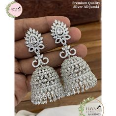 These stunning jhumka earrings are the perfect addition to any bride or bridesmaid's jewelry collection. They are made with high-quality materials and feature a beautiful kundan, beads, and cubic zirconia stones design. The earrings come in three colors: silver, white, and green and purple. The jhumkas are perfect for any wedding or engagement occasion. They are also a great gift for any woman who loves jewelry. Features: Made with high-quality materials Beautiful kundan, beads, and cubic zirconia stones design Available in three colors: silver, white, and green and purple Perfect for any wedding or engagement occasion Great gift for any woman who loves jewelry Materials: Kundan Beads Cubic zirconia stones Silver Care Instructions: To keep your jhumkas looking their best, simply wipe them Luxury Silver Kundan Bridal Earrings, Luxury White Stone Work Jhumkas, Luxury White Jhumkas For Reception, Luxury Silver Elegant Jhumkas, Luxury White Cutdana Jhumkas, Luxury Silver Kundan Jhumkas, Luxury Silver Dangle Jhumkas, Luxury Silver Jhumkas For Anniversary, Luxury Silver Chandbalis For Wedding