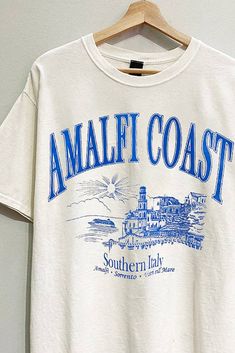 BACK IN STOCK! Embrace the coastal vibes this summer with our Amalfi Coast Graphic Tee. Crafted from premium washed cotton fabric, this tee offers a soft, lived-in feel that you'll love to wear all season long. The oversized fit ensures maximum comfort and style, making it a versatile addition to your summer wardrobe. The vibrant blue text pops against the fabric, bringing a touch of the Mediterranean to your everyday look. Perfect for pairing with denim shorts or a skort, this tee effortlessly