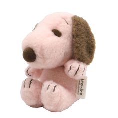 a pink stuffed dog with brown ears and paws