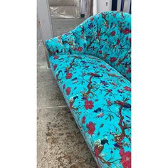 a blue couch sitting on top of a tiled floor