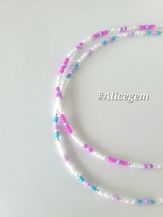 two strands of white, pink and blue beads on a white background with the word altgem