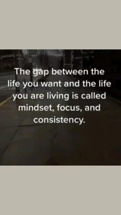 a person walking down the street with a quote on it that reads, the gap between the life you want and the life you are living is called minds