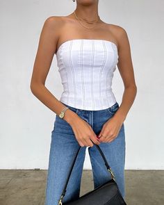 Step up your fashion game with our Irina Tube Corset Top! This stylish piece features a contrast stitch design and a convenient back zipper for easy wear. Perfect for any occasion, this top will elevate your look and get you compliments wherever you go! More Details: - Fits true to size - Does stretch - Back zipper - 74% Rayon 22% Nylon 4% Spandex - Color may vary due to the lighting - Model is wearing a size small Dress Home, Elevate Your Look, Stitch Design, Contrast Stitch, Corset Top, Easy Wear, Step Up, Fashion Games, Wardrobe Staples