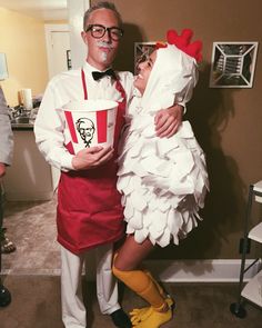 a man and woman dressed up as chicken and fries for halloween costume party, standing next to each other